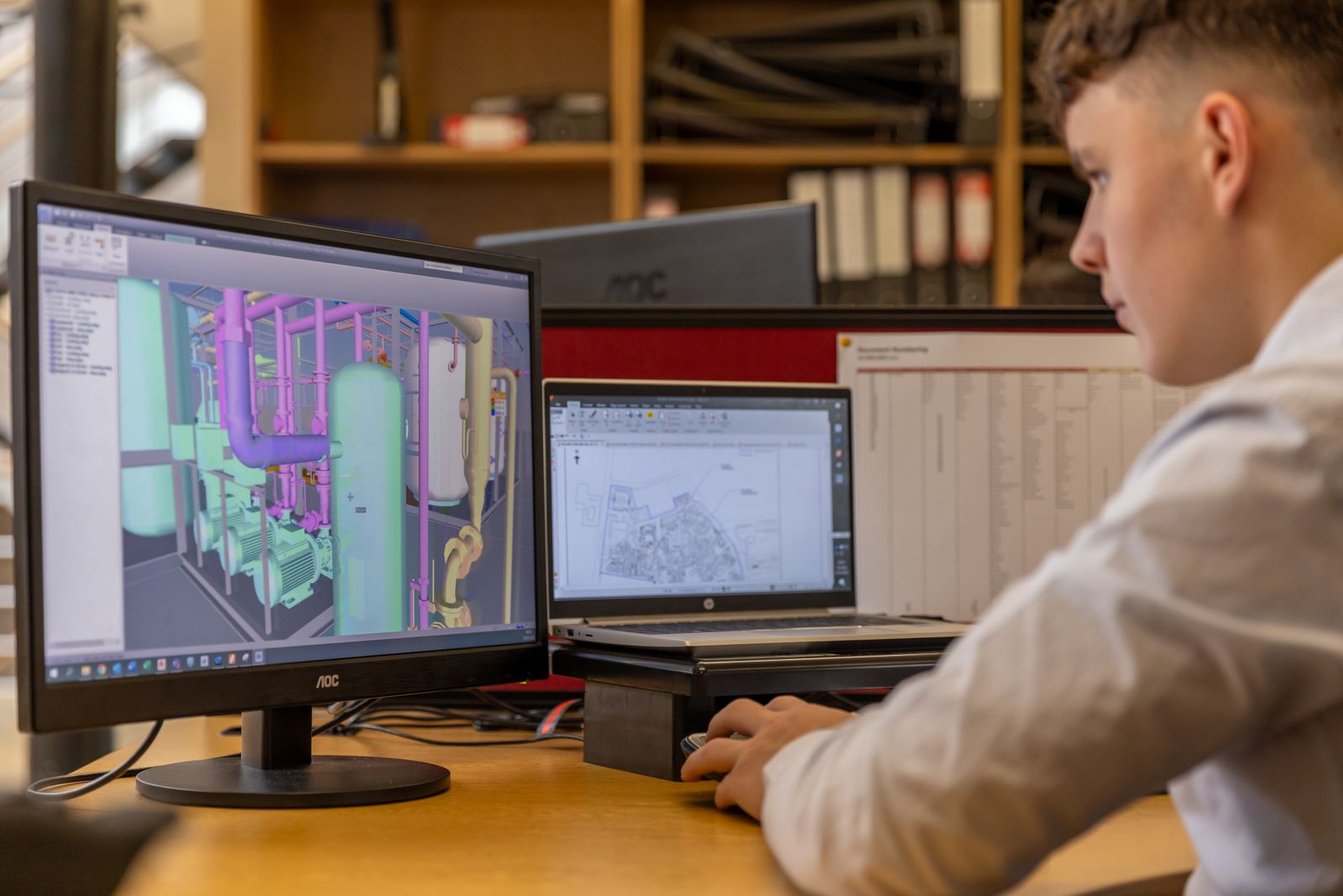 Engineer reviewing a technical drawing on screen