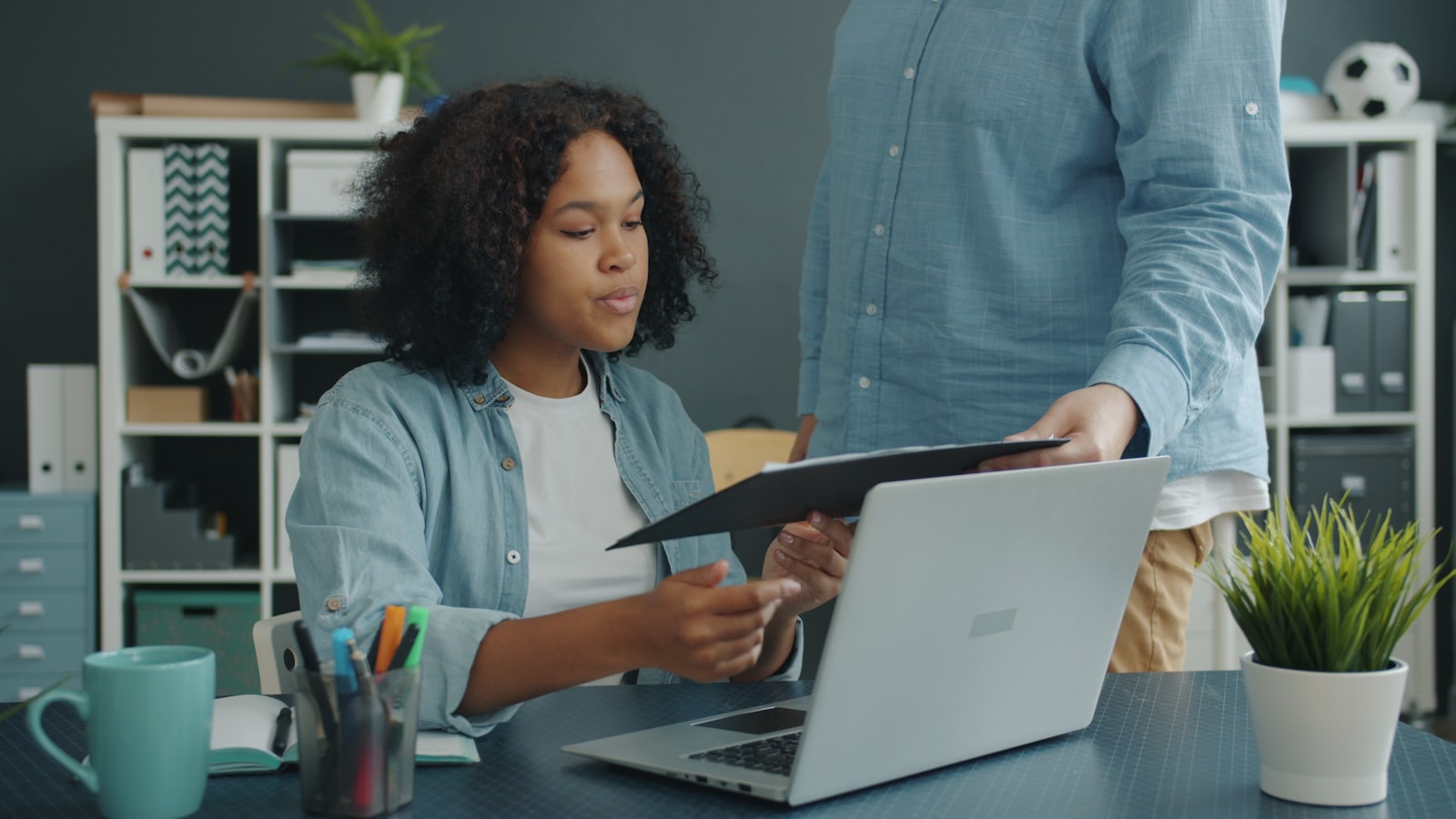Two colleagues reviewing a document together